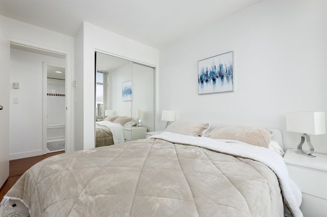 Bedroom featuring a closet, wood finished floors, and baseboards | Image 12