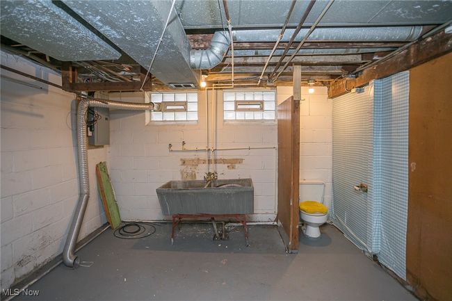 Below grade area with a sink and electric panel | Image 24