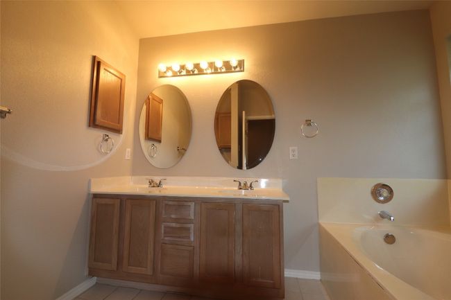 Full bath with a garden tub, double vanity, and tile patterned floors | Image 22