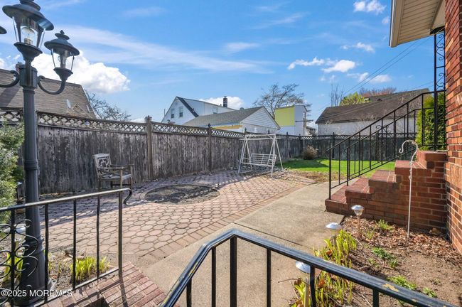 Backyard has pavers | Image 30