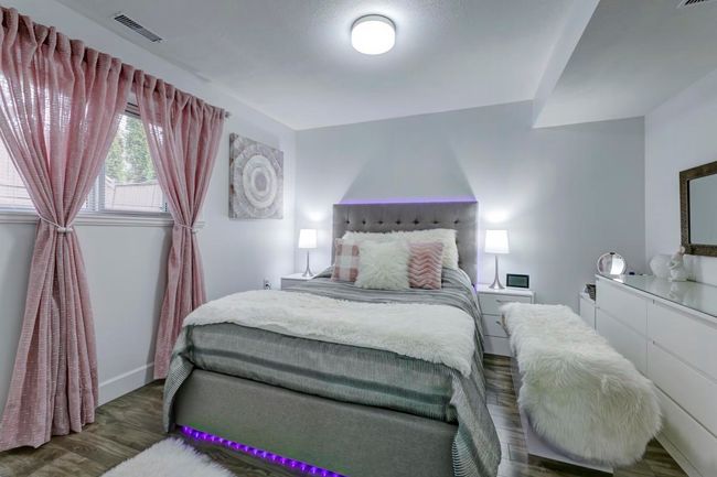 Bedroom with baseboards, wood finished floors, and visible vents | Image 11