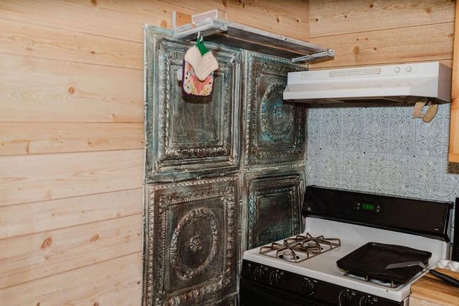 Kitchen with gas range and under cabinet range hood and accent wall | Image 7