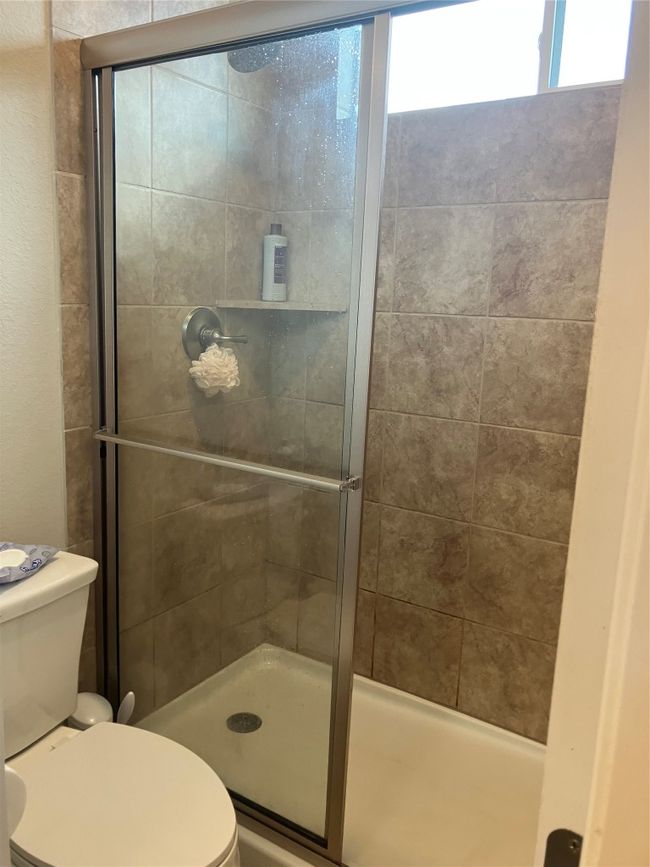 Bathroom with toilet and tiled shower | Image 22