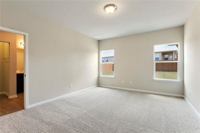 Carpeted empty room with healthy amount of natural light and baseboards | Image 12
