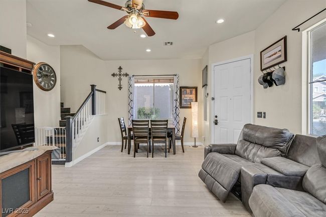 Living room featuring visible vents, recessed lighting, ceiling fan, stairs, and light wood-style floors | Image 6