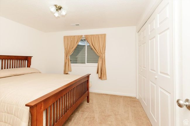 Carpeted bedroom with a closet | Image 56