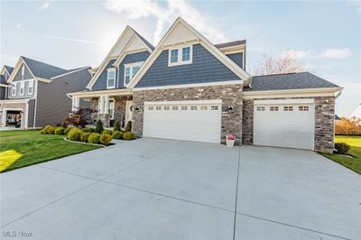 Craftsman-style home featuring a front lawn and a garage | Image 2