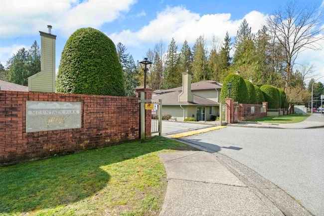 View of street featuring street lights, a gated entry, and sidewalks | Image 6
