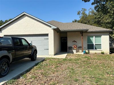 Single story home featuring a garage and a front lawn | Image 1