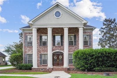 Prestigious three story waterfront home in the private gated neighborhood of Lake Ramsey Subdivision! | Image 1