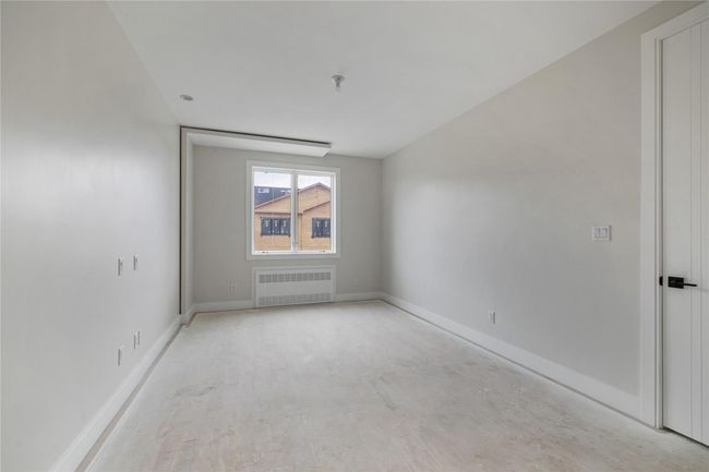 Unfurnished room with radiator heating unit and baseboards | Image 37