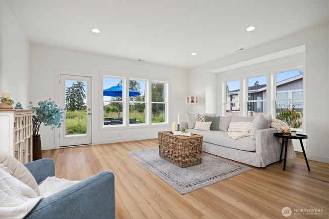 There are a lot of windows letting in an abundance of natural light into the home and particularly the living room. | Image 5
