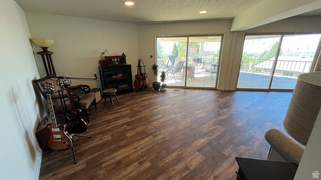 Sitting room featuring recessed lighting, wood finished floors, and a fireplace | Image 12