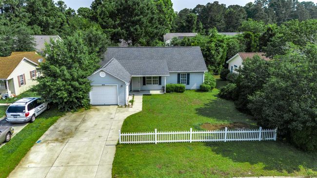 View of front of property featuring concrete driveway, a garage, a shingled roof, and a porch | Image 5