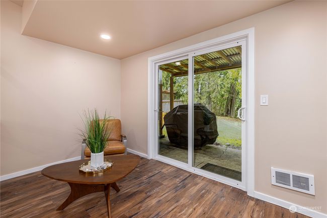 Basement. Patio sliding door leads out to back yard and water | Image 16
