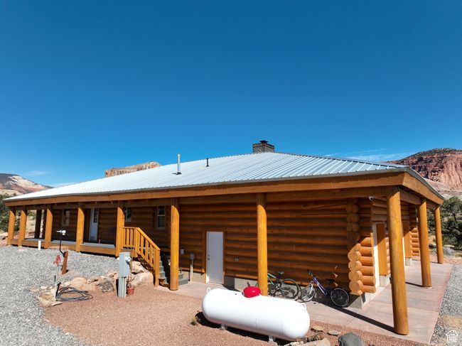 Back of house featuring metal roof, log exterior, and a mountain view | Image 46