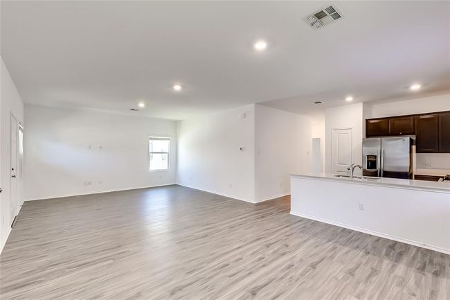 Unfurnished living room with recessed lighting, a sink, light wood-type flooring, and baseboards | Image 15