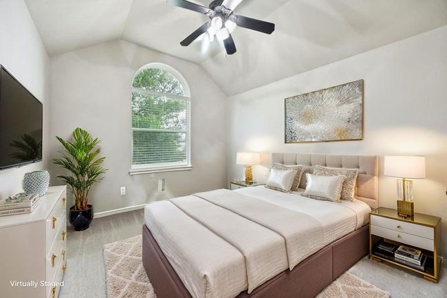 Bedroom with vaulted ceiling, wood finished floors, and a ceiling fan | Image 26