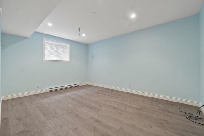 Bonus room with a baseboard heating unit, wood finished floors, and recessed lighting | Image 23