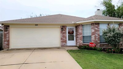 Ranch-style house with a garage and a front yard | Image 2