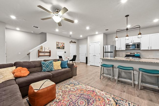 The living room effortlessly connects to the kitchen and dining area, offering a great space for both casual lounging and entertaining | Image 9
