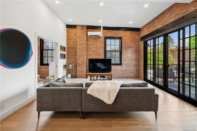 Featuring original architectural details- exposed brick, oversized windows, and abundant light. | Image 2