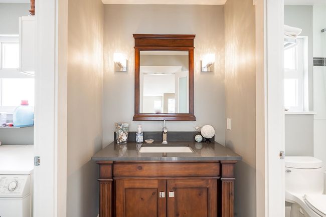 Bathroom with washer / clothes dryer, vanity, and plenty of natural light | Image 25