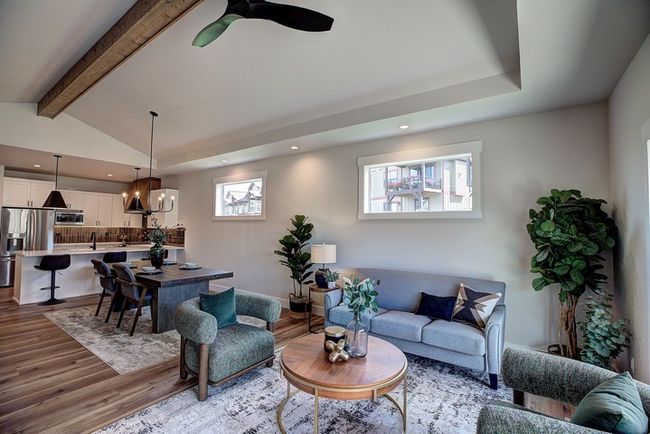 Living area featuring dark wood finished floors, a chandelier, recessed lighting, and ceiling fan | Image 20