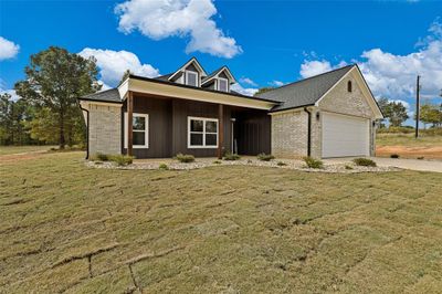 View of front of house featuring a front lawn and a garage | Image 2