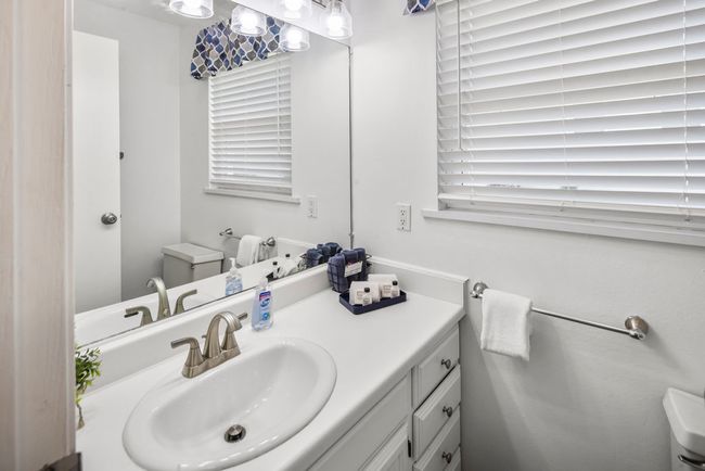 Bathroom featuring toilet and vanity | Image 12