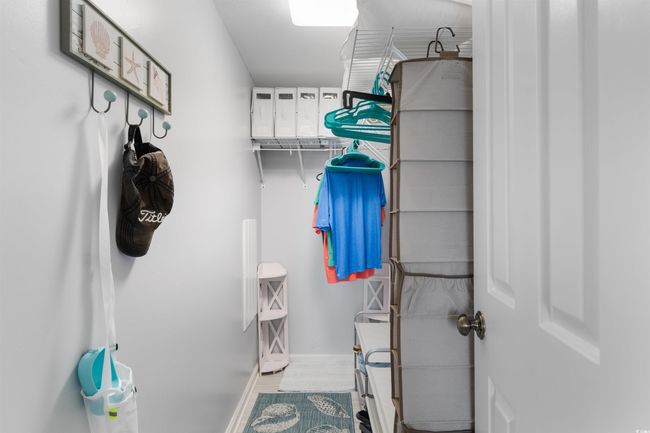 Walk in closet with wood finished floors | Image 16