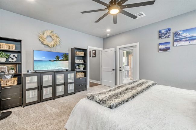 Bedroom with light colored carpet and ceiling fan | Image 23