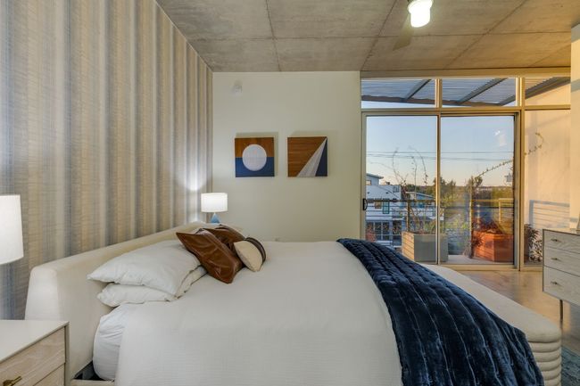 Bedroom with expansive windows and wood-type flooring | Image 23