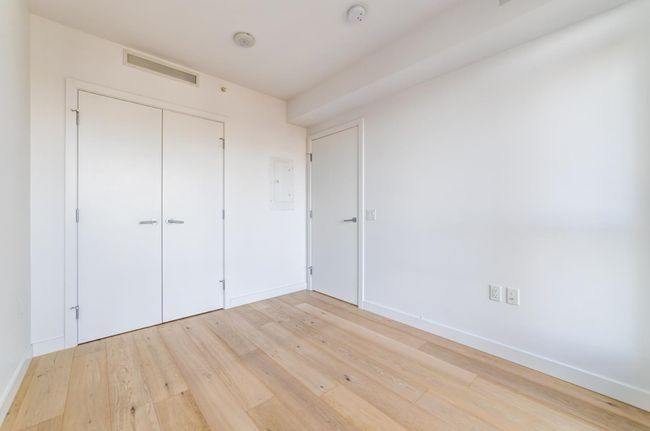 Unfurnished bedroom featuring a closet, light wood-type flooring, visible vents, and baseboards | Image 9