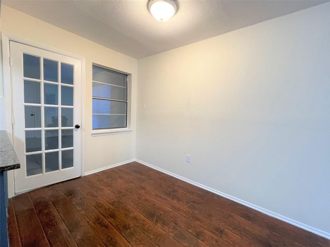 Empty room with dark wood finished floors and baseboards | Image 11