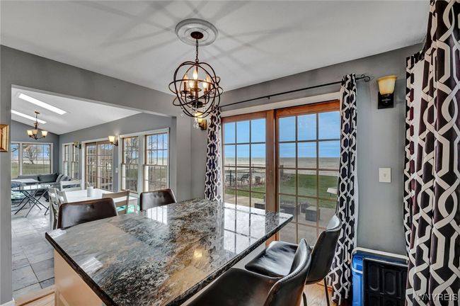 Wall of windows for amazing waterfront views from nearly every location in the house | Image 11