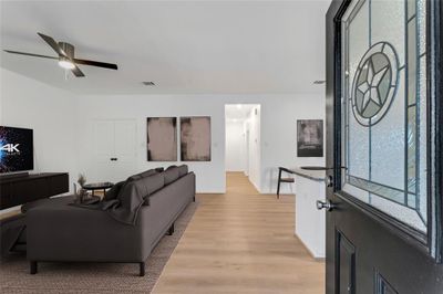 Step inside to a harmonious blend of spaces, where the living room, laundry room, and the kitchen island tantalize with their seamless integration. (Virtual Staging May Be Present) | Image 2