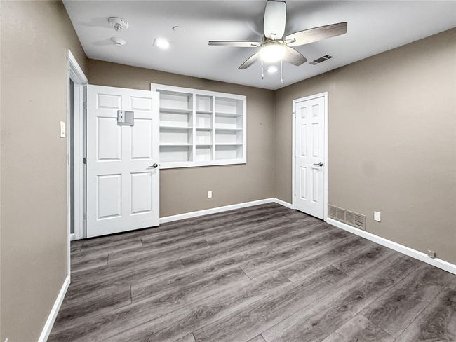 Unfurnished bedroom featuring dark wood finished floors, a ceiling fan, and recessed lighting | Image 34