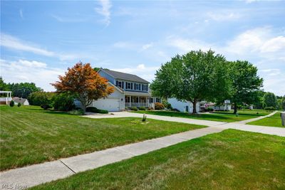 View of front facade with a garage and a front lawn | Image 2