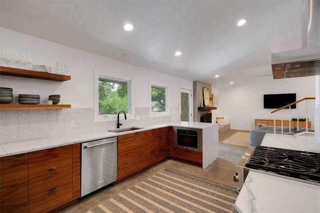Kitchen featuring appliances with stainless steel finishes, modern cabinets, and tasteful backsplash | Image 5