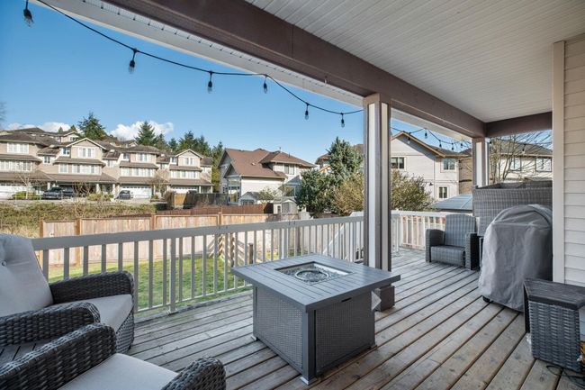 Wooden deck featuring a residential view, a fire pit, and fence | Image 37