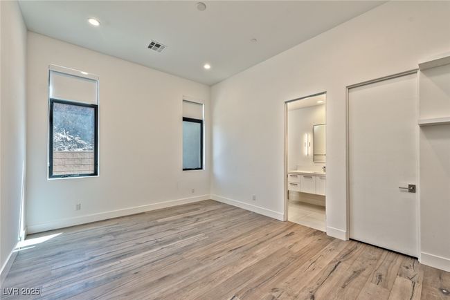 Unfurnished bedroom with visible vents, recessed lighting, light wood-style flooring, and baseboards | Image 9