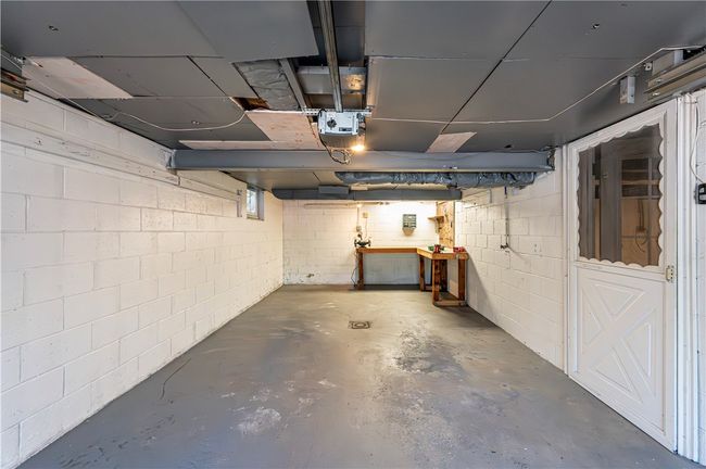 The nice deep garage with a back workbench and garage door opener. | Image 28