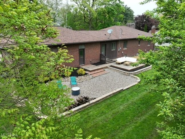 Back of house with a wooden deck, brick siding, and a lawn | Image 6