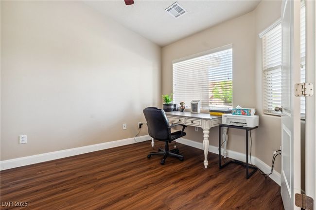 Home office featuring dark wood-style floors, baseboards, and vaulted ceiling | Image 8