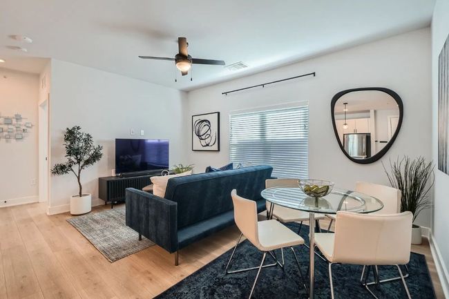 Dining space with light wood-style floors and a ceiling fan | Image 6