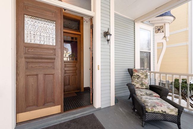 Step onto the open front porch, a nice spot for relaxing in good weather. Unit #1 has its own private double-door entry and tiled foyer. | Image 4