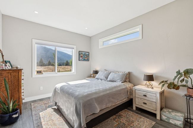 Bedroom featuring multiple windows, dark wood finished floors, recessed lighting, and baseboards | Image 27