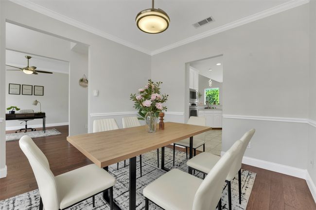 Dining area featuring ornamental molding, light wood-style flooring, and a ceiling fan | Image 8