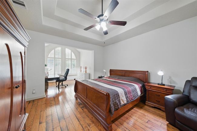 Master suite with tray ceiling and separate sitting area. | Image 24